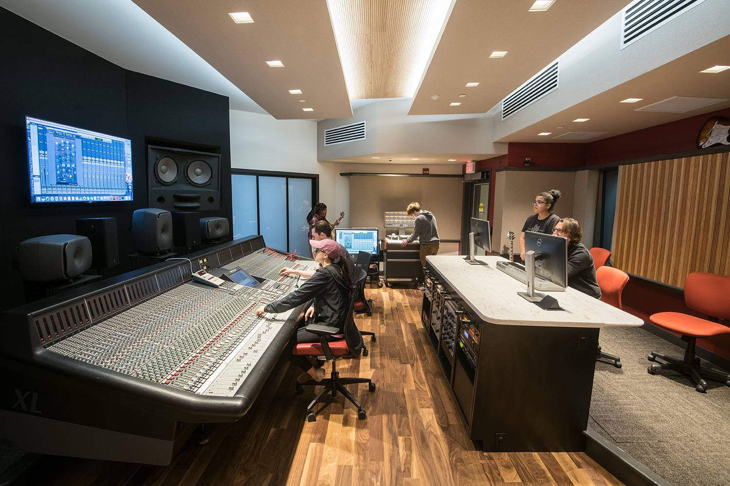 Montgomery County Community College in Blue Bell, PA brand-new Recording Studio for their Digital Music Technology course. Designed by WSDG. Architectural acoustics and media systems engineering. Control Room with MCCC students.