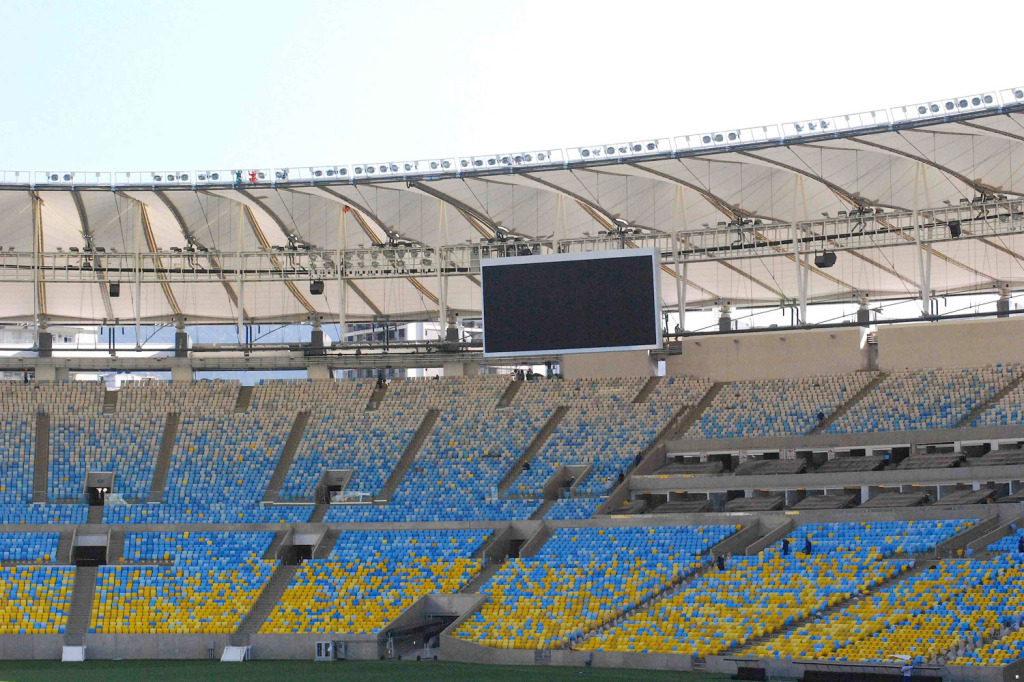 Maracana Stadium in Rio de Janeiro, Brazil. One of the biggest soccer stadiums in the world, home of the 2014 Olympic Games and World Cup. WSDG was called for consulting and installation of the audio/video of the whole facility. Long shot of the screen and seats.